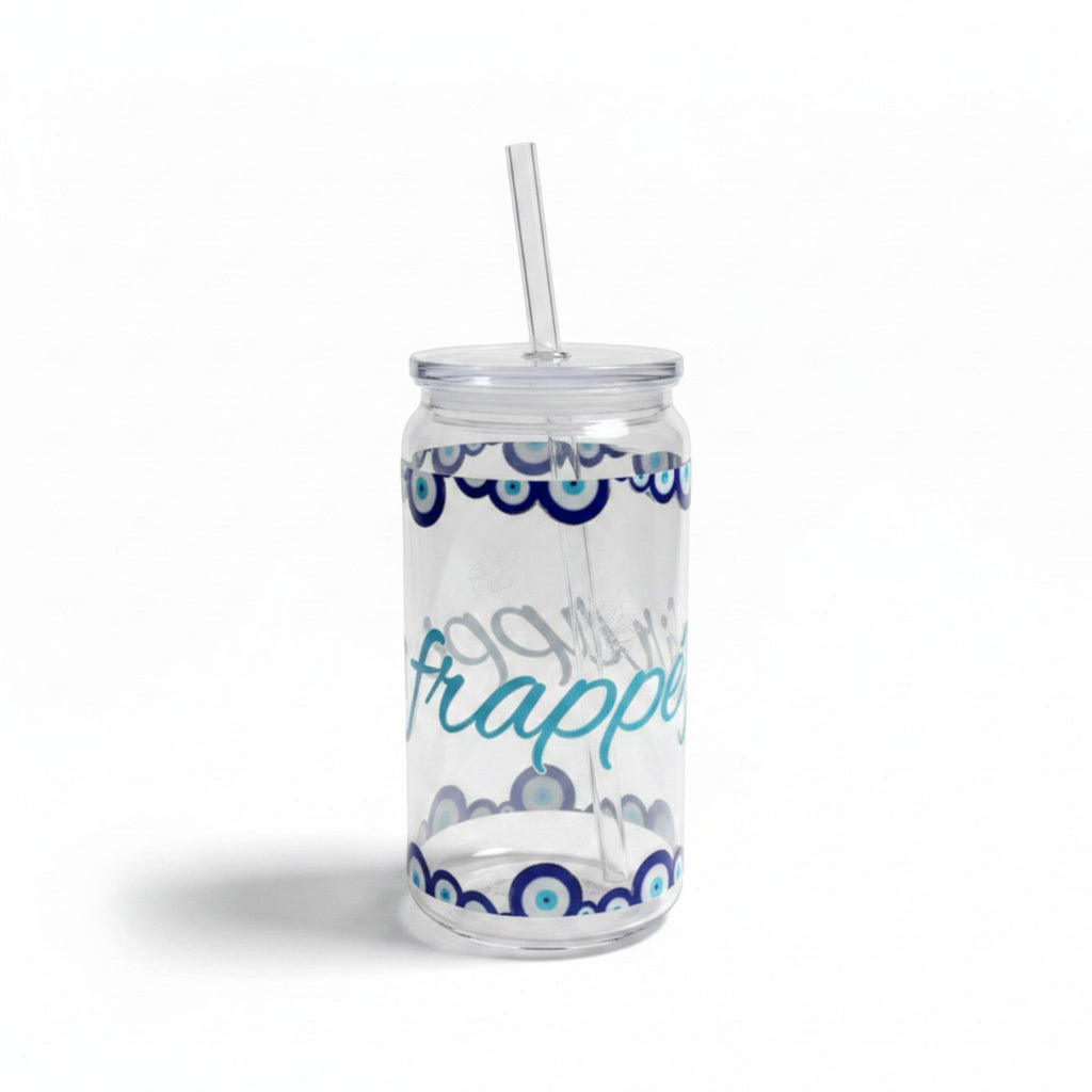 Mati Made clear glass can-shaped tumbler with blue evil eye motif, lid, and reusable straw for iced drinks.
