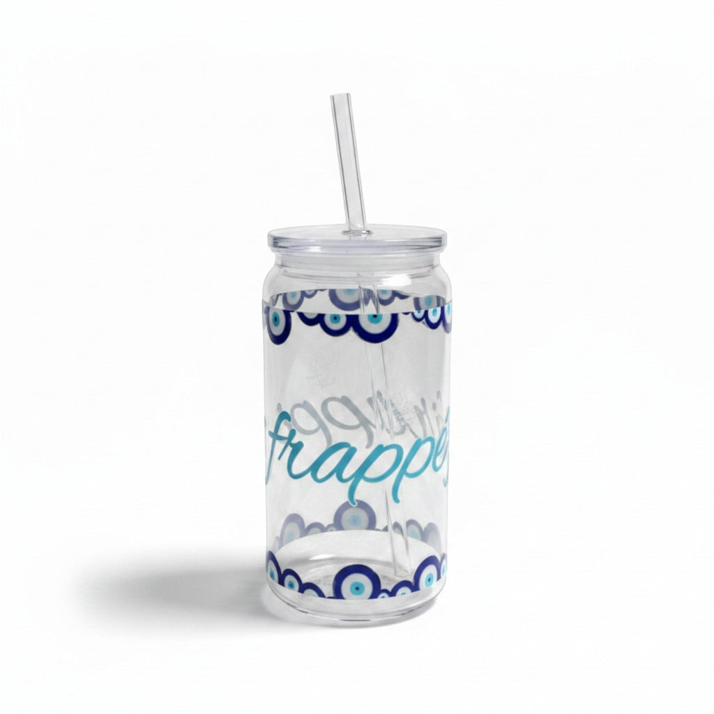 Mati Made clear glass can-shaped tumbler with blue evil eye motif, lid, and reusable straw for iced drinks.
