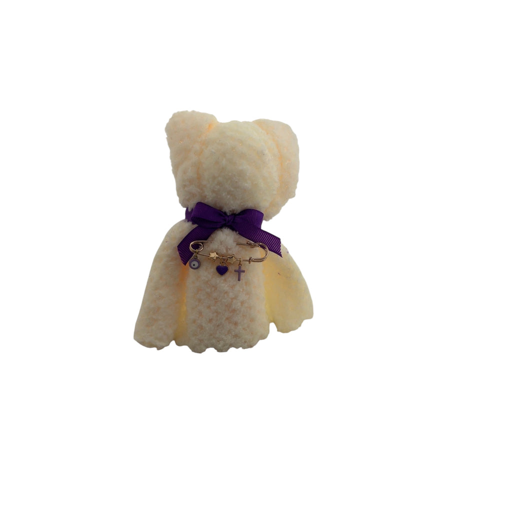 Mati Made cream plush teddy bear ornament with a purple ribbon and gold charm safety pin featuring heart and cross.