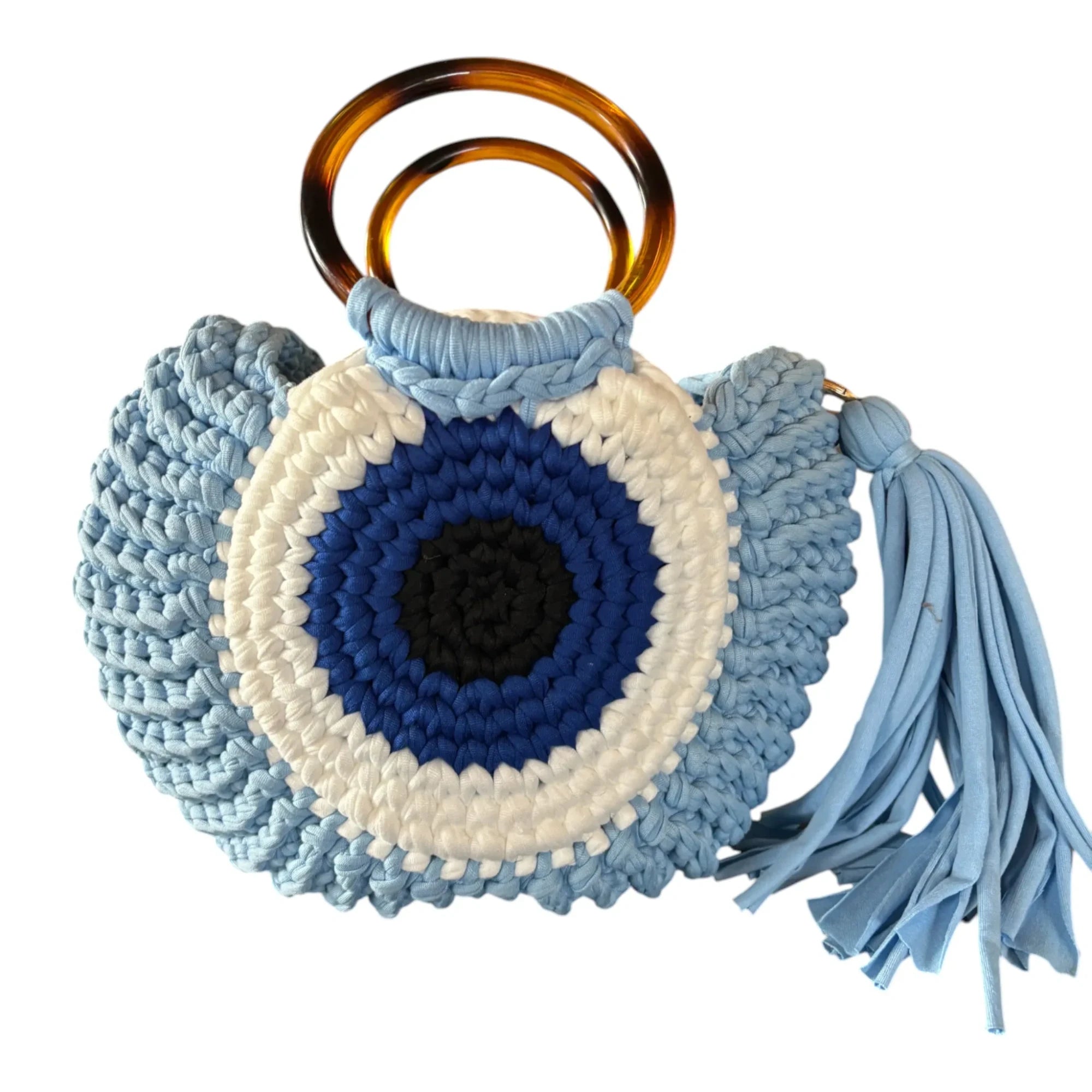 Mati Made handcrafted crochet tote bag featuring a blue, white, and black evil eye motif with tortoiseshell handles.