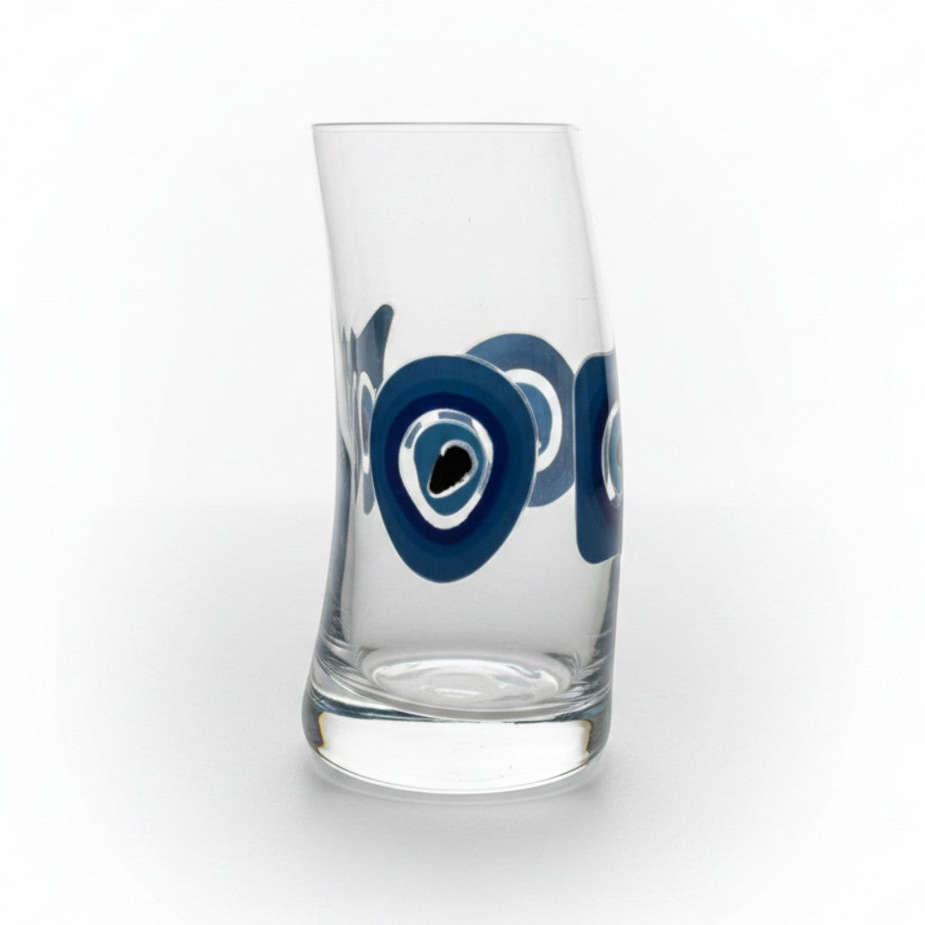 Mati Made clear glass tumbler featuring a curved silhouette and a blue and black evil eye design.