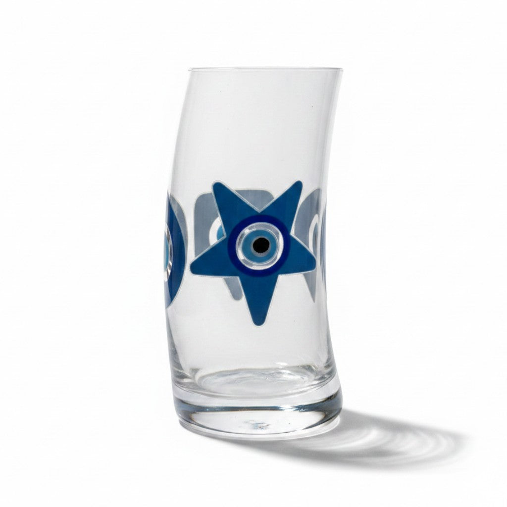 Mati Made clear glass tumbler featuring a blue and black star-shaped evil eye design with a curved silhouette.
