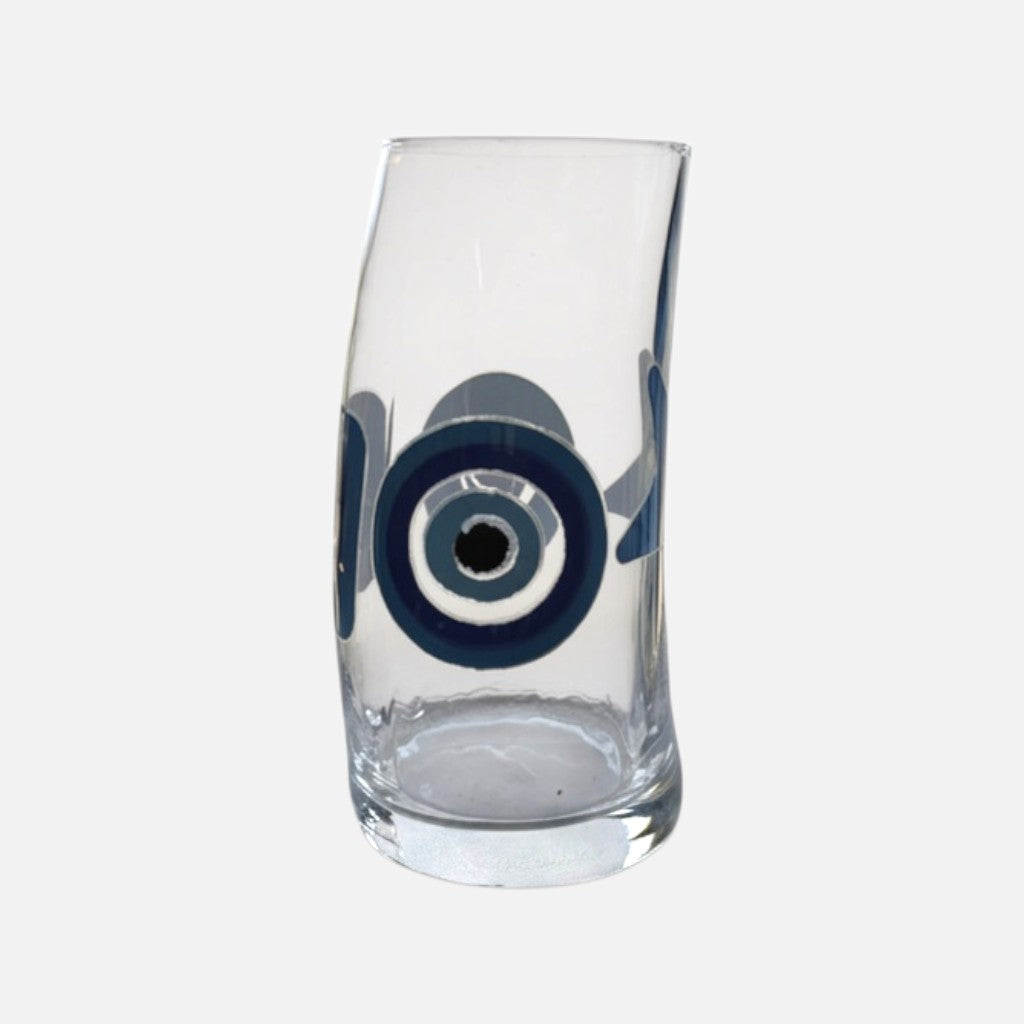 Mati Made clear glass tumbler featuring a blue and black evil eye design with a unique curved silhouette.