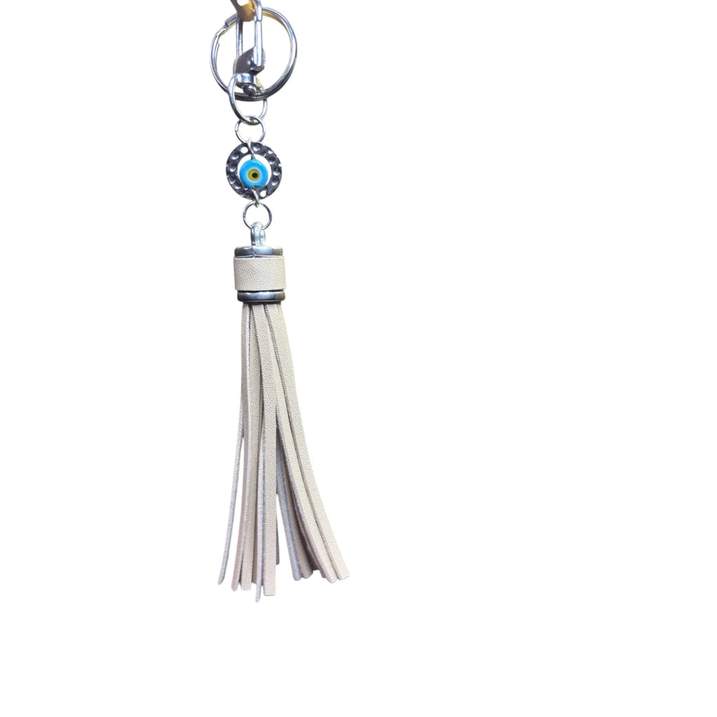 Mati Made evil eye keychain with a neutral faux leather tassel and silver-tone hardware for bags or keys.