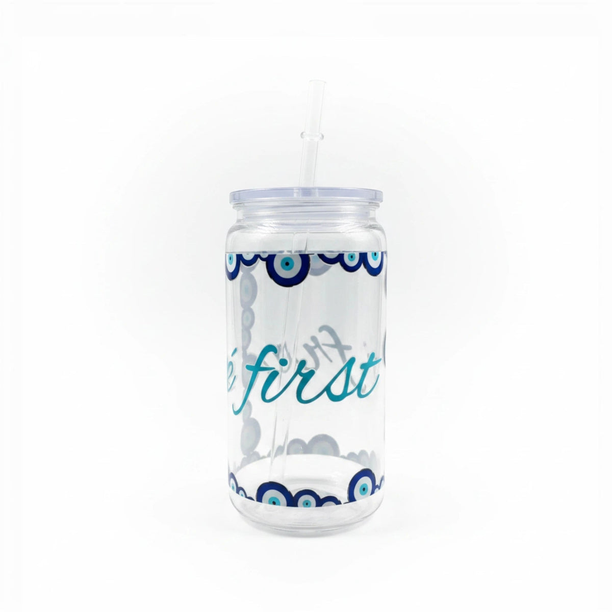 Mati Made clear glass can-shaped tumbler with evil eye rim patterns, lid, and reusable straw on a white background.