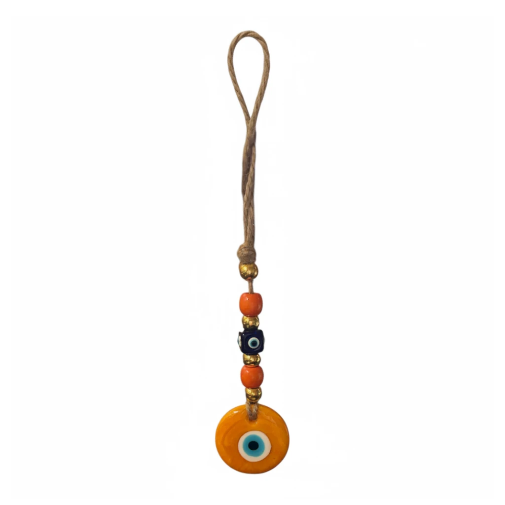 Mati Made decorative evil eye wall hanging with orange and black beads on a rustic jute cord for home protection.