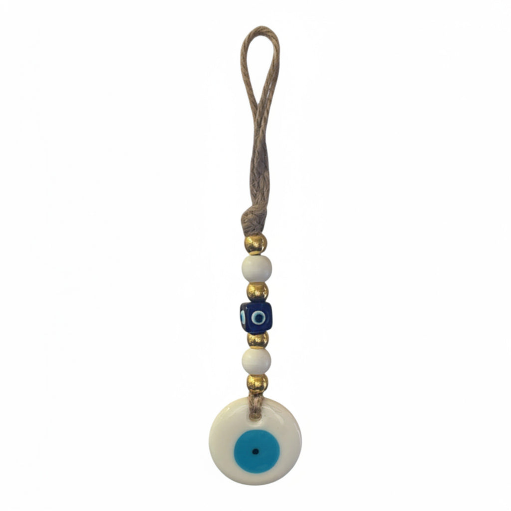 Mati Made evil eye wall hanging ornament with blue and white beads on a rustic jute cord for home protection