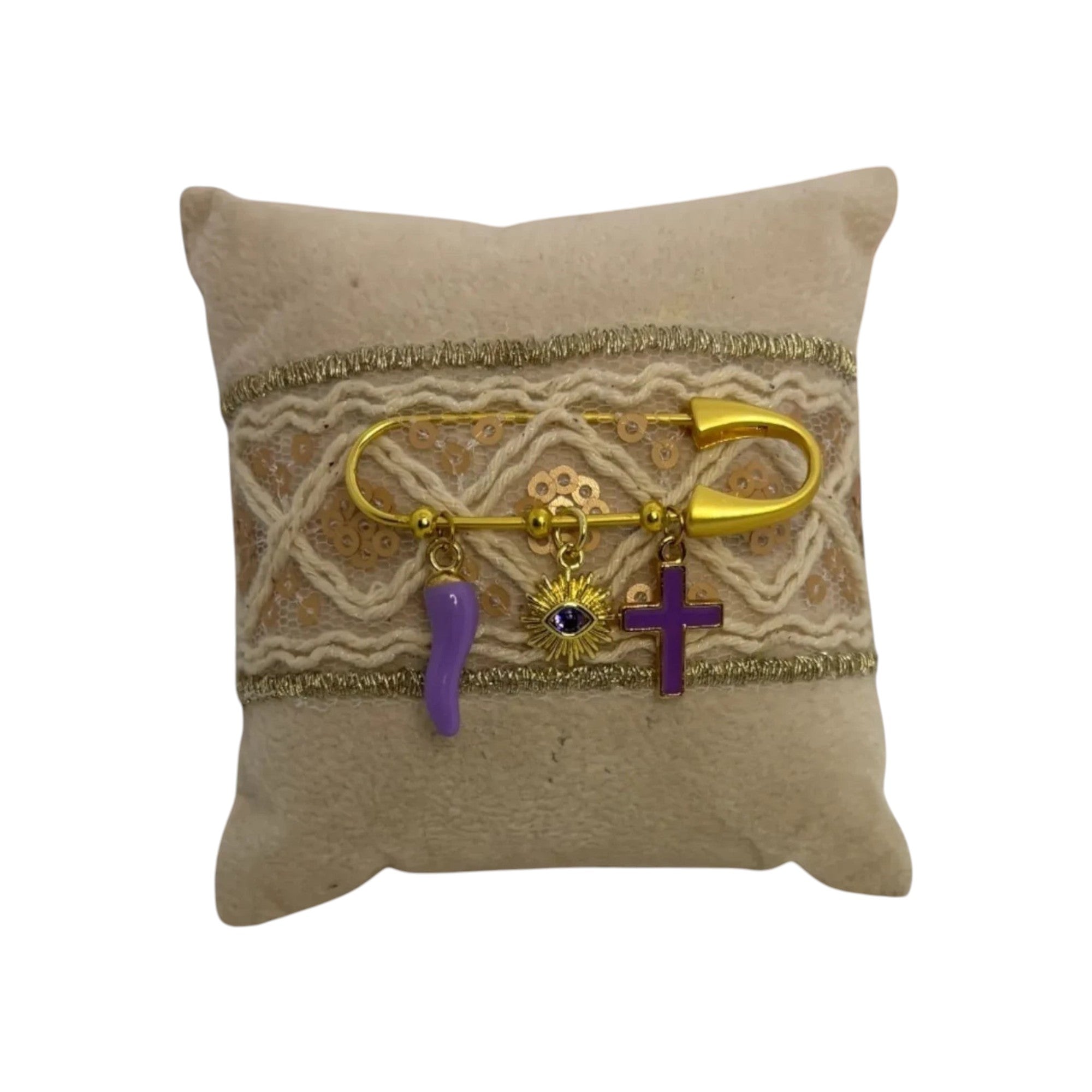 Mati Made handcrafted beige teddy cloth pillow with gold trim, purple chilli, mati sun, and cross charms.