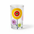 Mati Made clear glass tumbler featuring colorful whimsical floral circular patterns in yellow, pink, and green.