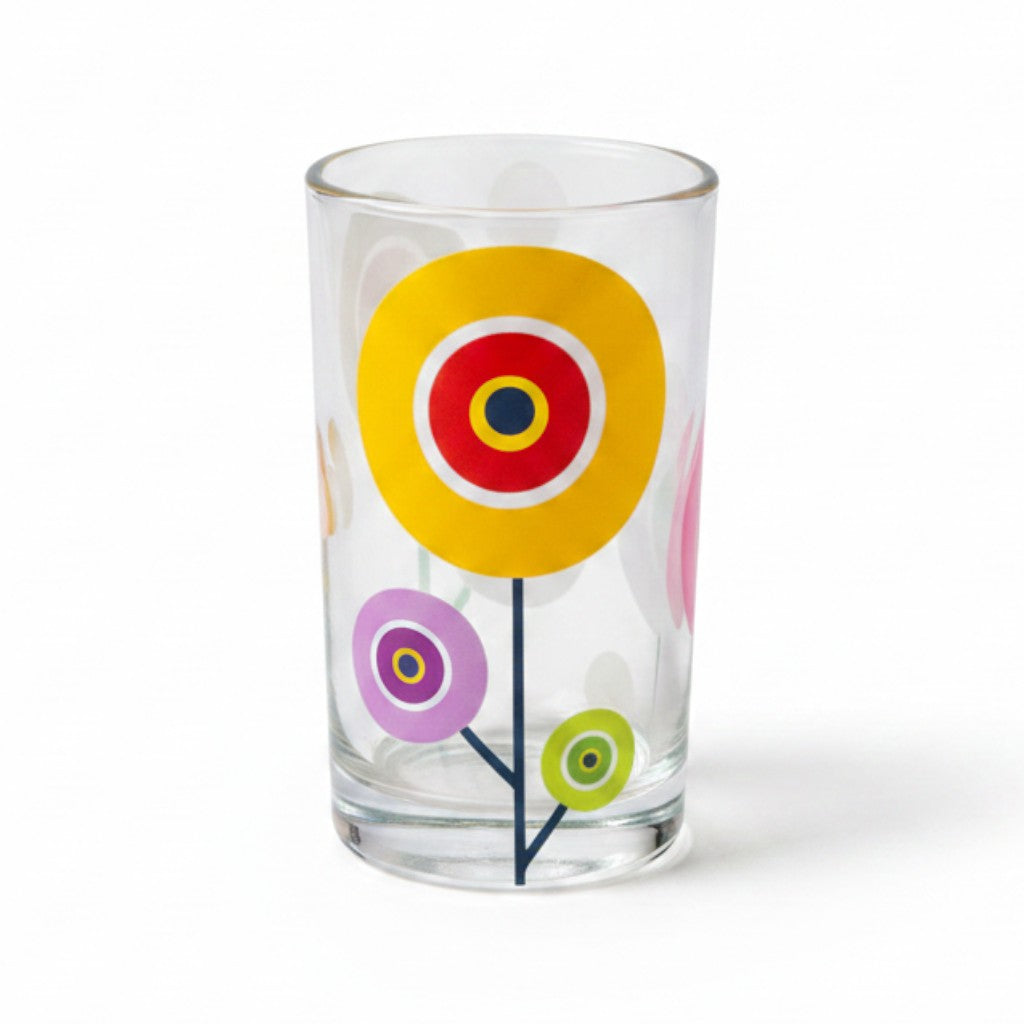 Mati Made clear glass tumbler featuring colorful whimsical floral circular patterns in yellow, pink, and green.