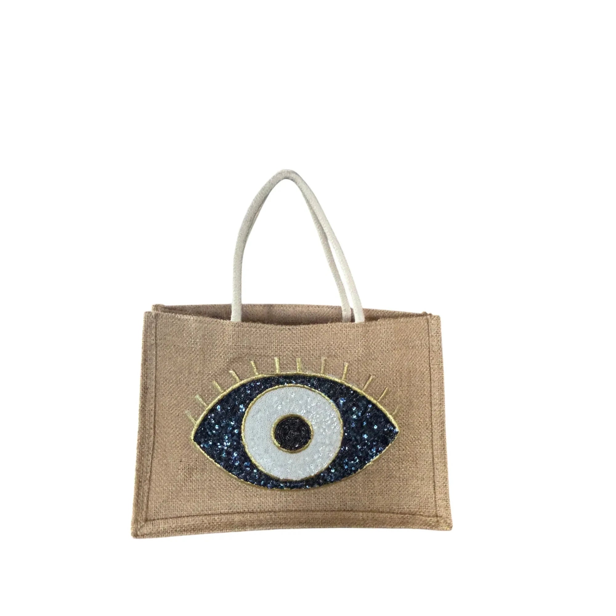 Mati Made natural jute tote bag featuring a sequined evil eye motif in blue, white, and black with gold accents.