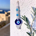 Mati Made handcrafted macrame evil eye wall hanging with white cotton cord and vibrant turquoise beads