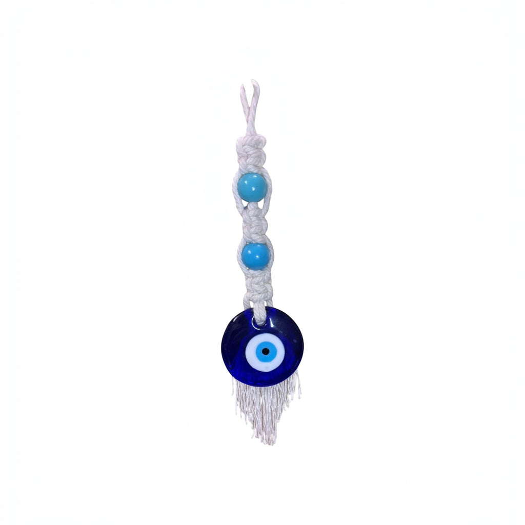 Mati Made handcrafted macrame evil eye wall hanging with white cotton cord, turquoise beads, and blue glass charm.