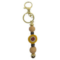 Mati Made mustard silicone bead key ring with gold hardware and evil eye charm accent for keys or bags.