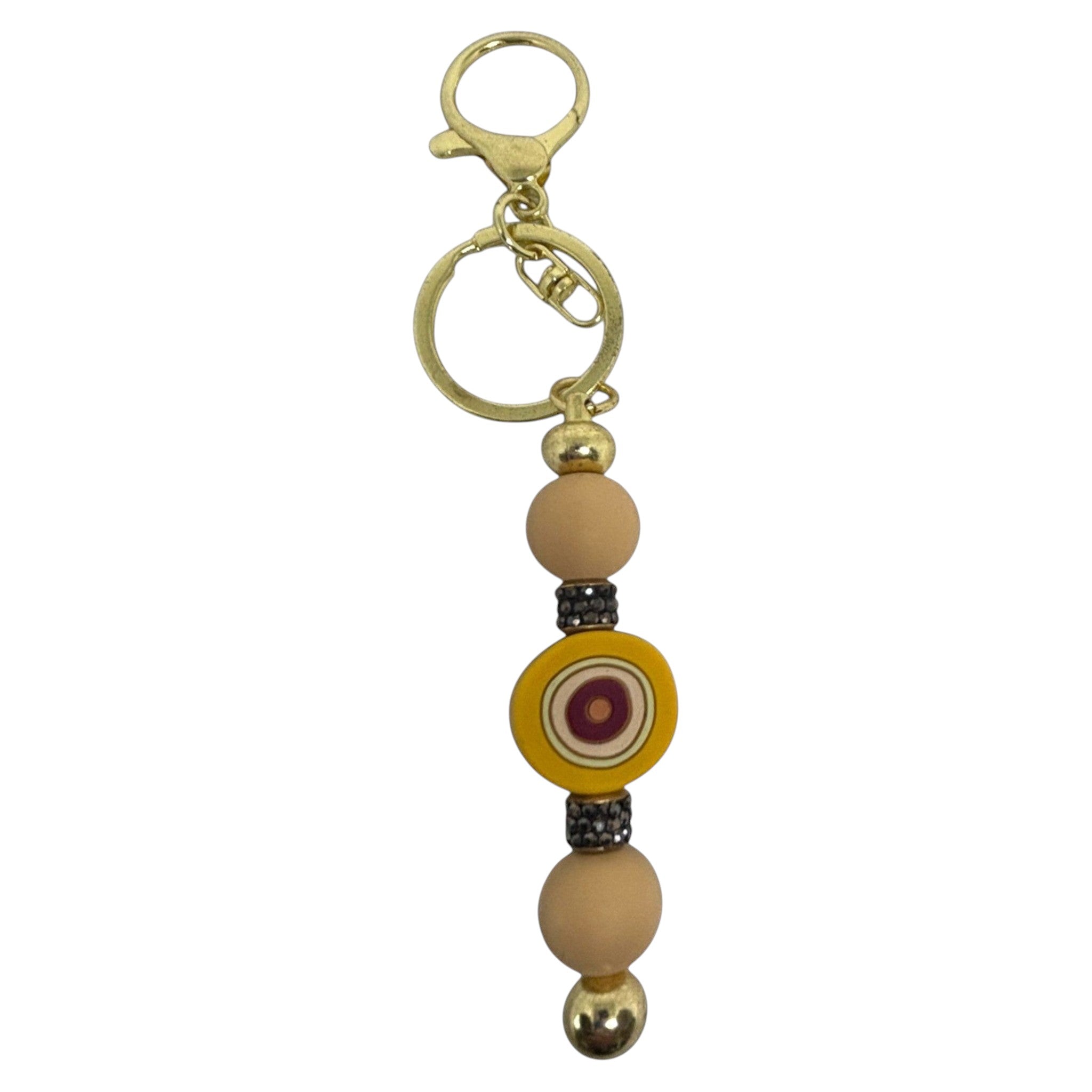 Mati Made mustard silicone bead key ring with gold hardware and evil eye charm accent for keys or bags.