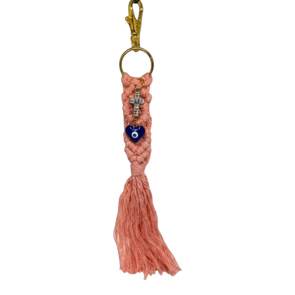 Mati Made pink macramé keychain featuring a sparkling cross and blue heart mati charm with a gold clasp.